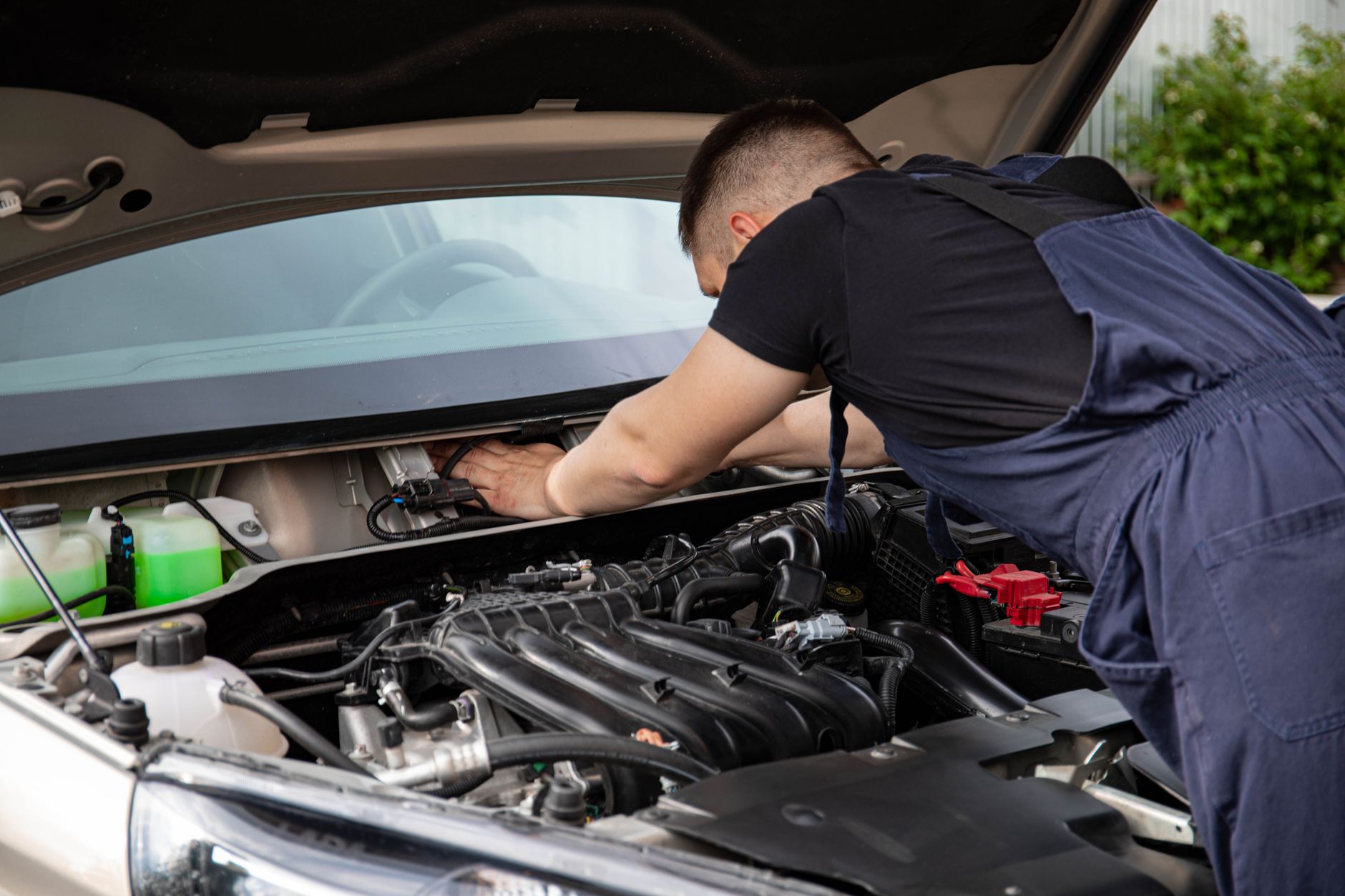 mechanic working on car engine